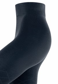 Collant neri con una superficie liscia, un elastico rigato in vita e un sottile motivo a rombi lungo la gamba per un tocco di dettaglio in più.
