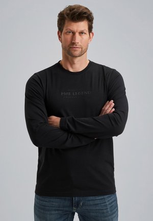 Zwarte langemouwen t-shirt met een ronde hals en een bedrukte logo in het midden. Gemaakt van zacht materiaal met een aansluitende stijl.