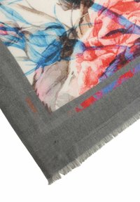 Soft, gray scarf featuring a floral print in red, blue, and brown tones. Edges are fringed, enhancing the textile texture.