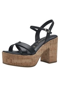 Black platform sandals with cross-strap design, cork block heel, smooth leather upper, and a textured cork base. Adjustable ankle strap included.