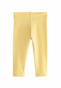 Sárga leggings, puha, könnyű anyagból készültek. Jellemzője rugalmas derékpánt és egyszerű, varrás nélküli design.