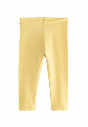 Gule strækleggings lavet af blødt, let stof. Har en elastisk talje og et enkelt, sømløst design.