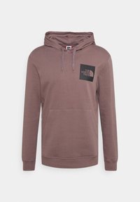 Sudadera con capucha en un color marrón apagado, hecha de una tela suave. Presenta un bolsillo tipo canguro en la parte delantera y un parche de logo negro en el pecho.