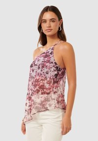 Sleeveless, sheer blouse with a pink and purple floral pattern, asymmetrical hemline, and delicate spaghetti straps.