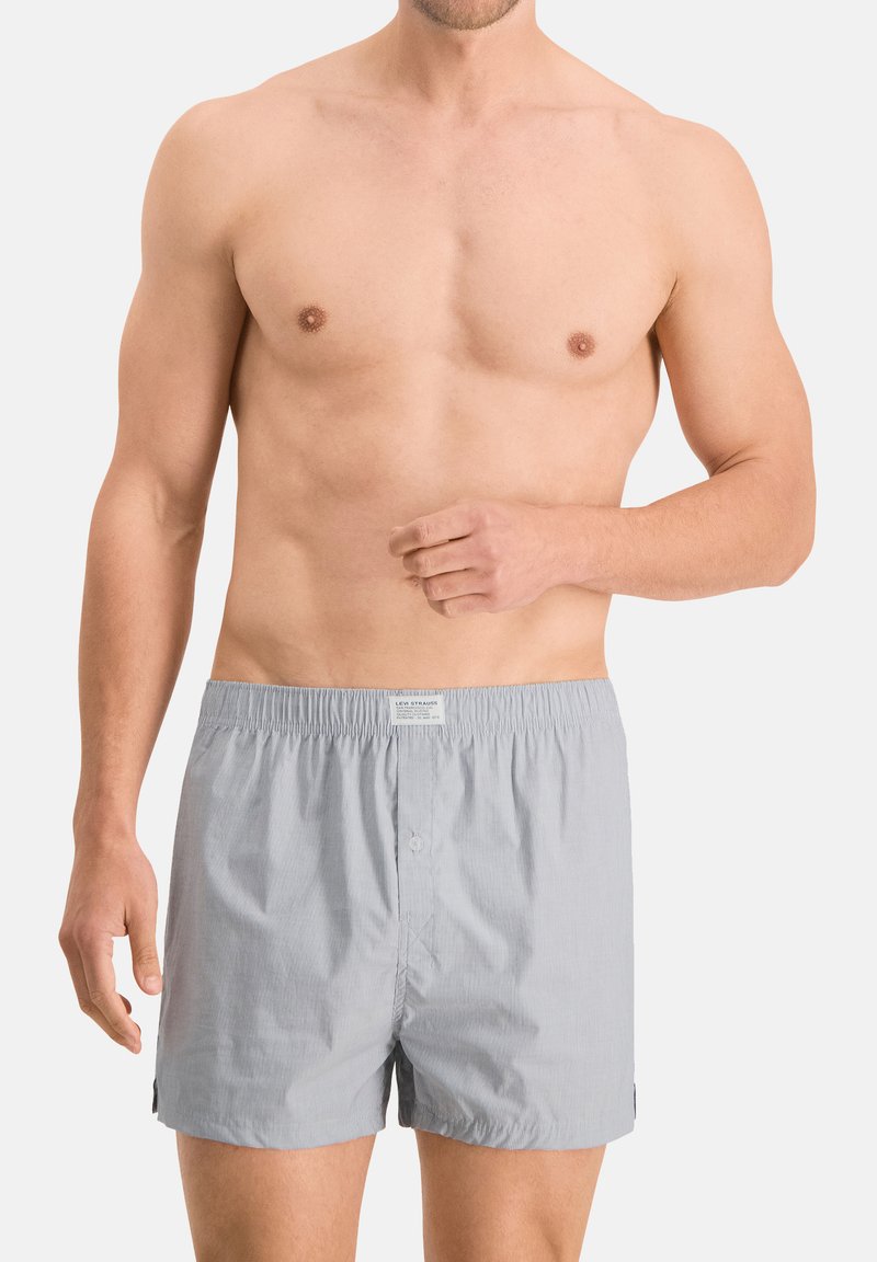 Herren Boxershorts in Grau mit Streifen aus weicher Baumwolle. Merkmale sind ein elastischer Bund und ein Knopfverschluss sowie seitliche Schlitze für Bewegungsfreiheit.
