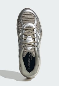 Srebrna atletska tenisica s mrežastim gornjim dijelom, teksturiranim detaljima, bež vezicama i podstavljenim uloškom s oznakom "CLOUDFOAM COMFORT".