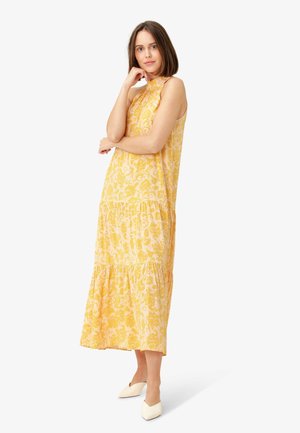 Robe maxi imprimée floral jaune avec un col volanté et un bas en plusieurs niveaux, fabriquée en tissu léger, dotée d'une coupe décontractée.