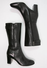 Black leather ankle boots with a sleek design, featuring a zip closure and accent strap. Standard block heel for stability.