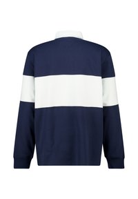 Navy blue long-sleeve polo shirt featuring a white horizontal stripe across the center and collar. Made of soft fabric with a relaxed fit.