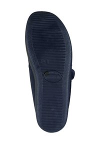 Black rubber shoe sole with ribbed texture, rounded shape, and a smooth, flat bottom section. Features a circular logo detail at the center.