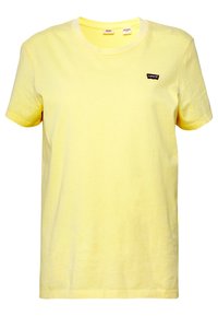 Žluté bavlněné tričko s kulatým výstřihem, krátkými rukávy a malým černým logem Levi's na hrudi. Měkká textura a ležérní design.