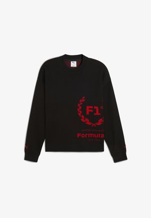 Črni pulover z rdečimi grafikami, vključno z "F1" in obliko lovorike, z rebrastim ovratnikom in manšetami, narejen iz mehkega blaga.