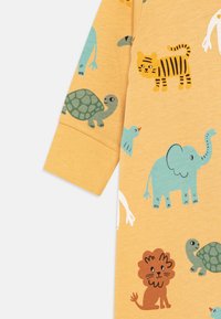 Lindex JUNGLE UNISEX - Pižame - dusty yellow