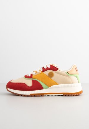 Sneakers with a beige mesh upper, red and yellow suede accents, green details, and a white sole. Features a round logo on the side.
