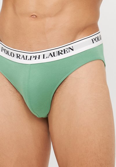Grüne Baumwollslips mit einem weißen Gummibund, auf dem "POLO RALPH LAUREN" in schwarzer Schrift steht. Glatte Textur, enganliegendes Design.