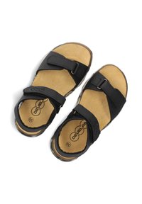 Black leather sandals with two adjustable straps, cushioned tan insole, and transparent sole. Logo visible on the footbed.