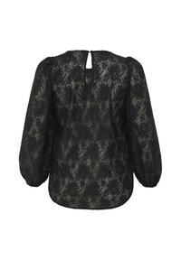 Blouse en dentelle noire avec de longues manches bouffantes, motif floral, détail en trou de serrure au dos, et une silhouette ample et fluide. Tissu texturé et semi-transparent.
