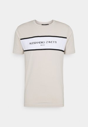 Light beige short-sleeve T-shirt with a white horizontal panel bordered in black featuring "Alessandro Zavetti Milano" text on the chest.