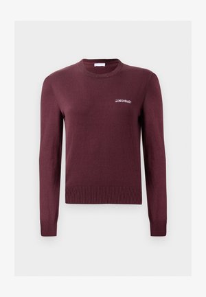 Maroon crew-neck sweater made of soft knit fabric. Features ribbed cuffs and hem, with a small white logo on the chest.