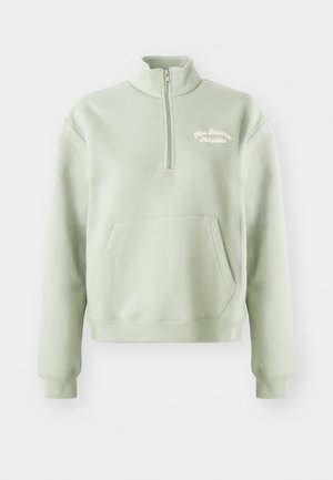 Light green zip-up sweatshirt with a high collar, kangaroo pocket, and embroidered "New Balance Athletics" logo on the chest. Soft texture.