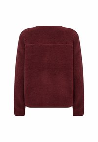 Burgundy fleece pullover with a textured, cozy fabric. Features a straight cut and a horizontal seam detail across the upper back.
