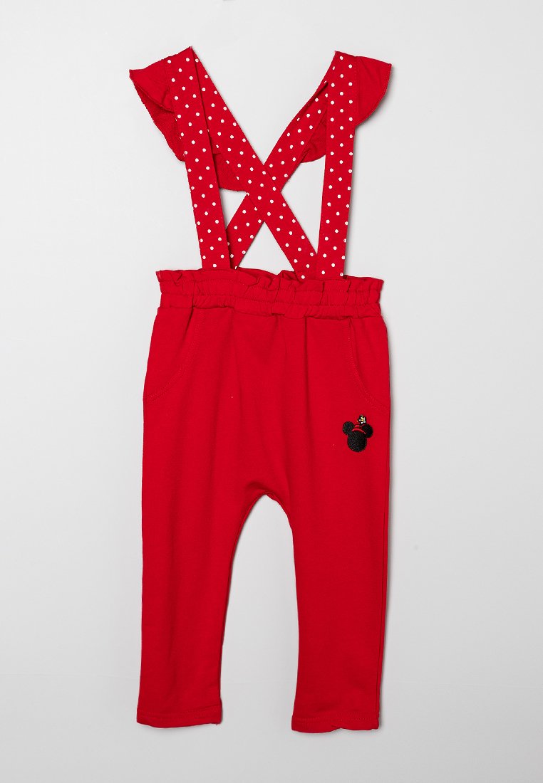 Rote Kleinkinderhosen mit weißen Punkten, überkreuzten Trägern und einem kleinen schwarzen Mäusekopf-Emblem auf dem rechten Oberschenkel.