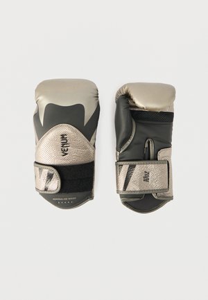 Een paar bokshandschoenen in metallic goud en zwart met klittenbandsluitingen, waarvan er één de palmzijde toont en de andere de achterkant met merknaam.