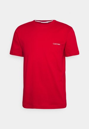 Red cotton t-shirt featuring a round neck and short sleeves, with a small white logo on the chest. Smooth texture and classic fit.