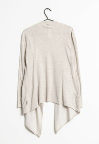 Světlý béžový cardigan s otevřeným předním dílem, dlouhými rukávy, zakřiveným lemem a bočními kapsami. Vyrobeno z texturované, jemné tkaniny.