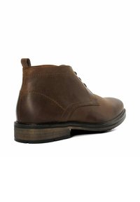 Brown leather ankle boot with a round toe, low heel, and lace-up design. Features visible stitching and a pull tab at the back.