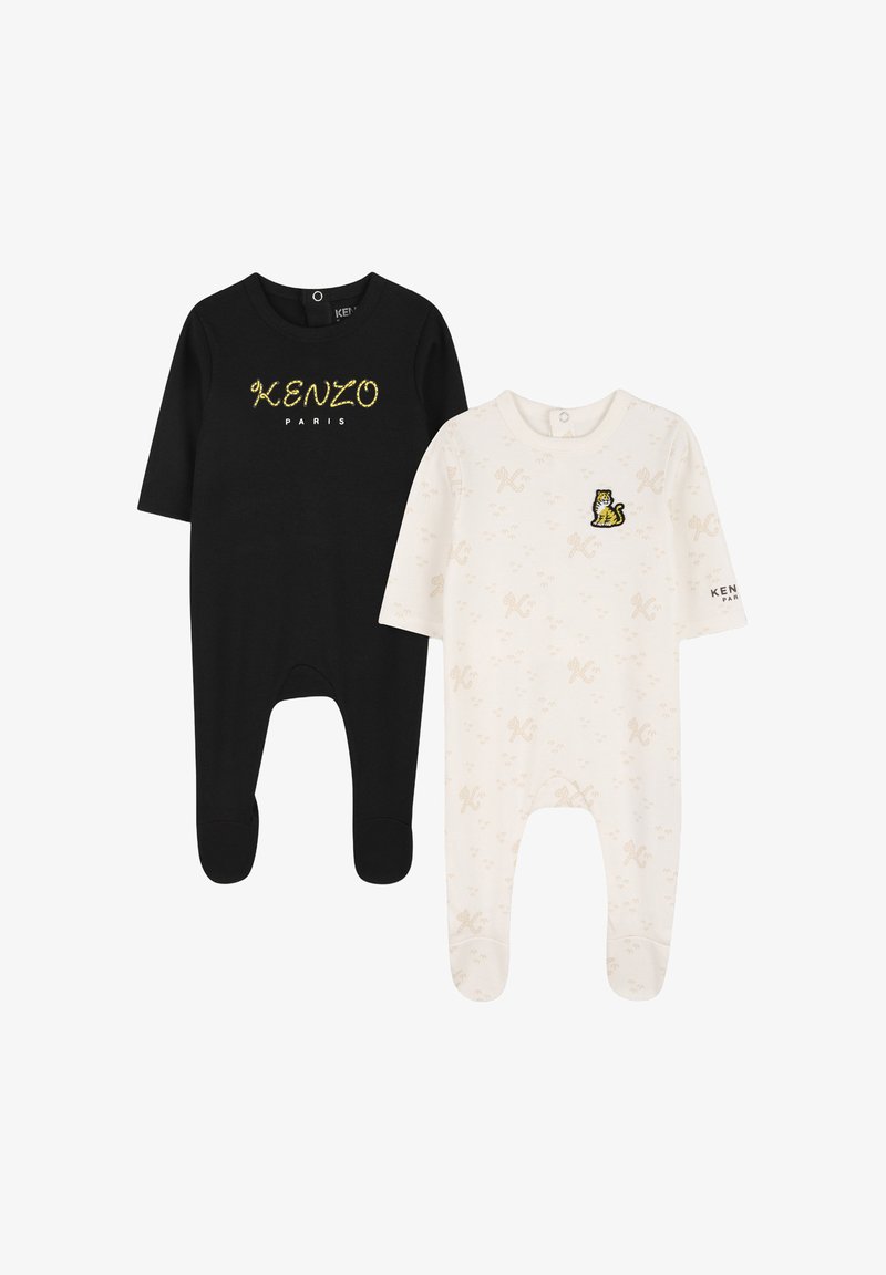 Set di due body per neonati: uno nero in cotone con scritta dorata "KENZO PARIS" e uno bianco con toppa a forma di tigre e motivi chiari.