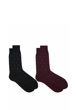 Dos pares de calcetines hasta la mitad de la pantorrilla, uno negro y otro granate oscuro, cada uno con pequeños lunares blancos distribuidos uniformemente.