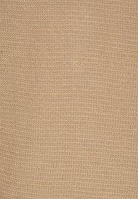 Beżowa tkanina o teksturowanym, prążkowanym wzorze, lekka z gładką powierzchnią. Odpowiednia do zastosowań odzieżowych lub tapicerskich.