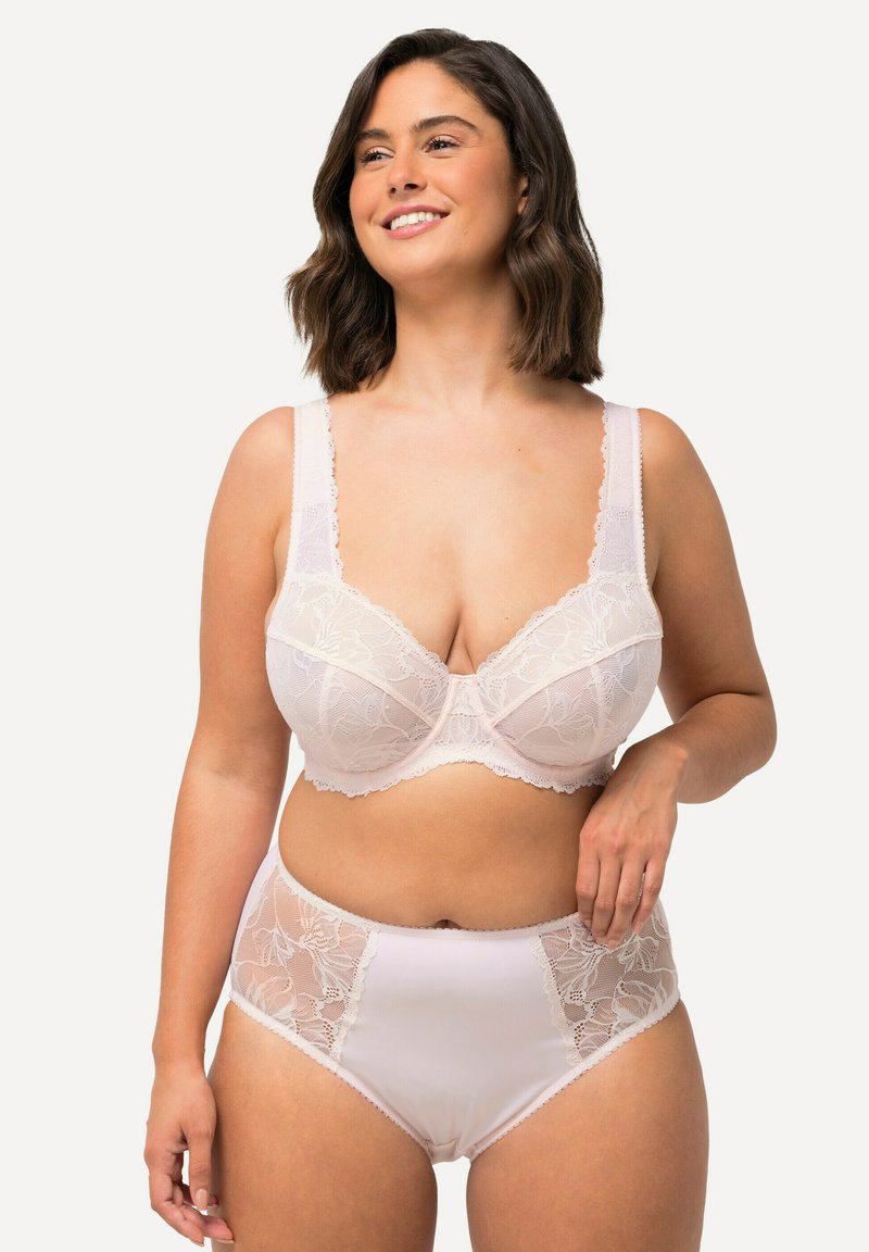 Kanten beha en hooggesneden slip in zachtroze. Voorzien van bloemranden en brede bandjes, met een soepel en comfortabel draaggevoel.