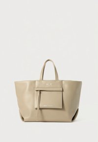 Saco tote bege texturado com alças duplas, um bolso frontal com fecho de correr e detalhe do logótipo em relevo no painel frontal.