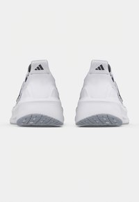 Valkoiset urheilukengät, joissa on kuvioitu pohja, sileä päällinen ja mustat logoyksityiskohdat. Ominaisuuksiin kuuluu pehmustettu kantapää ja hengittävä muotoilu.