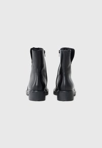 Black leather ankle boots with a smooth texture, rounded toes, and a short block heel. Features a side zipper for easy wear.