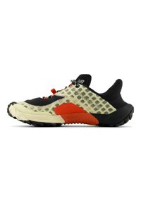 Multi-colored athletic shoe with a black upper, mesh texture, translucent yellow panels, red accents, and a rugged black outsole.