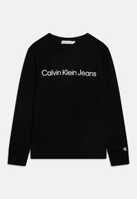 Felpa nera in cotone con maniche lunghe e scollo rotondo. Presenta la scritta bianca "Calvin Klein Jeans" sulla parte anteriore e il logo sulla manica.