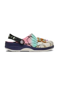 Zueco colorido tipo slip-on con correa ajustable negra en el talón, charm en forma de mariposa, y un degradado en rosa, verde azulado y crema con un patrón negro en forma de telaraña.