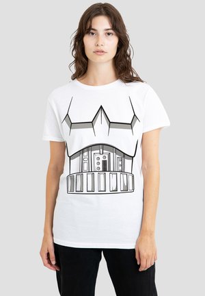 White cotton t-shirt featuring a black graphic design of a futuristic building with angular lines and geometric shapes.