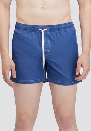 Pantaloni da bagno blu realizzati in tessuto leggero, con cordino bianco, vita elasticizzata e cuciture bianche lungo le cuciture.