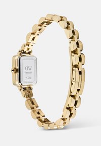 Gold-toned metal watch with rectangular face showing serial number and stainless steel back, linked bracelet strap, and clasp.