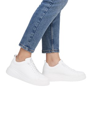 White sneakers with a smooth leather upper, round toe, and a raised, textured sole. Features lace-up closure and rear tab for easy wear.