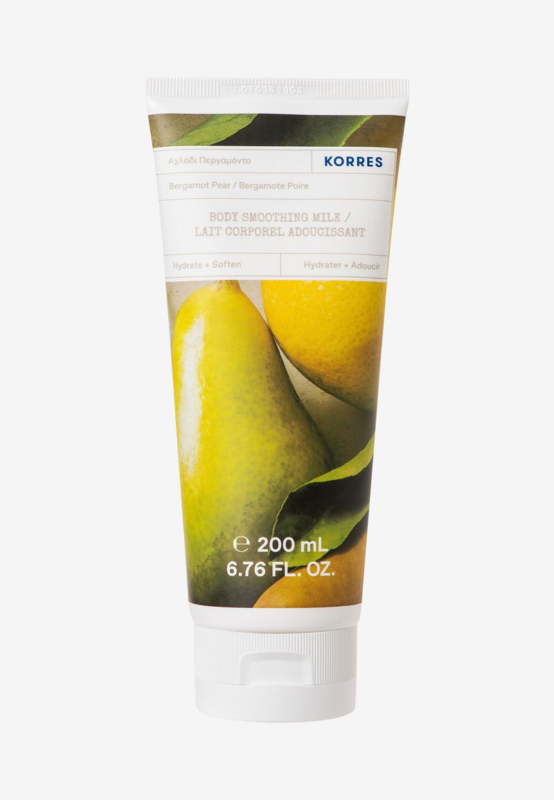 Lait lissant pour le corps dans un tube à presser. Le design présente des illustrations vibrantes de poire et de bergamote sur un fond blanc.