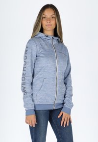 Light blue hooded sweatshirt made of soft material. Features front zip, two side pockets, and "SWEDEMOUNT" printed on the sleeve.