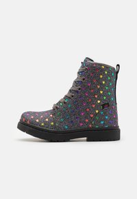 Botín gris con una parte superior brillante que presenta patrones de corazones multicolores, puntera redonda, suela plana y diseño de cordones con una lengüeta.