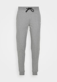 Grau Sweatpants aus weichem Stoff, mit einem elastischen Bund und schwarzem Kordelzug, schmal zulaufenden Bündchen und dezentem Branding an der Seite.