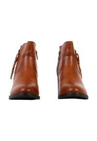 Paire de bottines en cuir marron avec fermetures éclair latérales et talons bas noirs, présentées de face sur fond blanc.