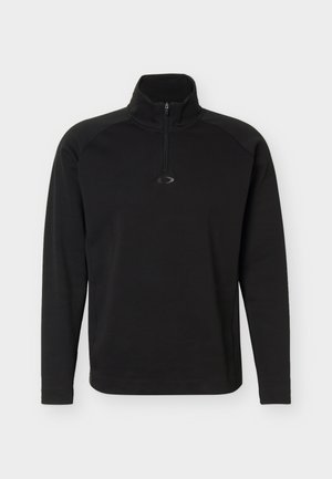 Čierny dlhý pulóver s dlhým rukávom so štvrťzipsom a malým stredovým logom pod golierom, vybavený vysokým golierom a raglánovými rukávmi.